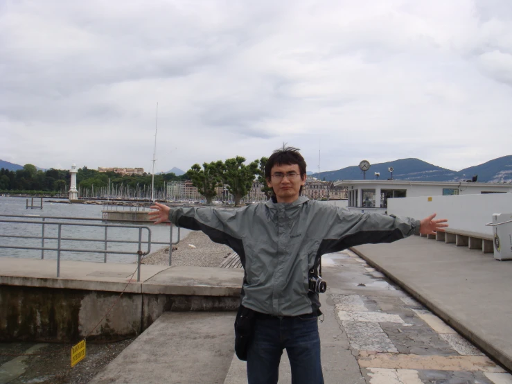 a man is posing for the camera with his arms stretched out