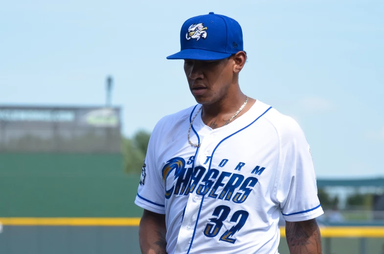 a baseball player wearing a blue and white hat