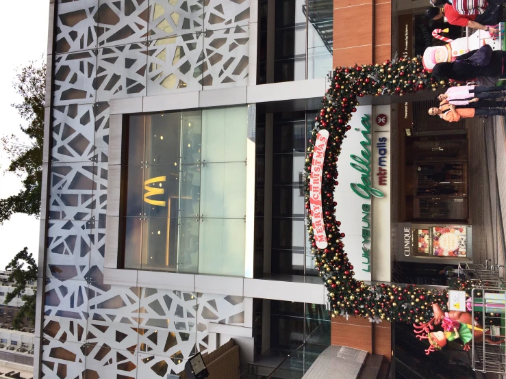 a mcdonald's on the street with lots of people and decorations