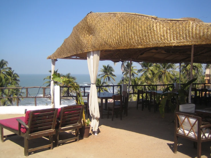 a covered restaurant with chairs and tables at an overlook