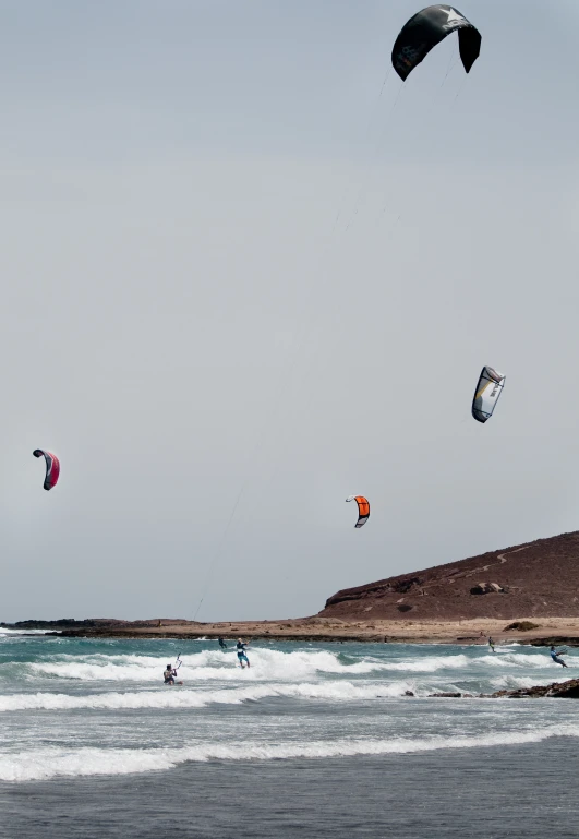 the parasails are in the air over the beach