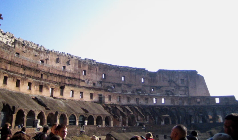 a crowd of people standing in front of an old building