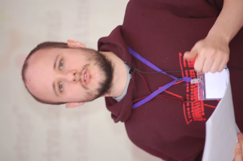 a man holding a piece of paper and talking