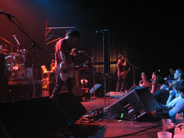 a group of people on a stage with band members