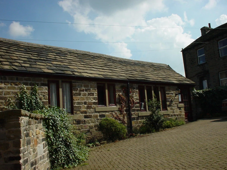 two brick buildings and a stone paved road