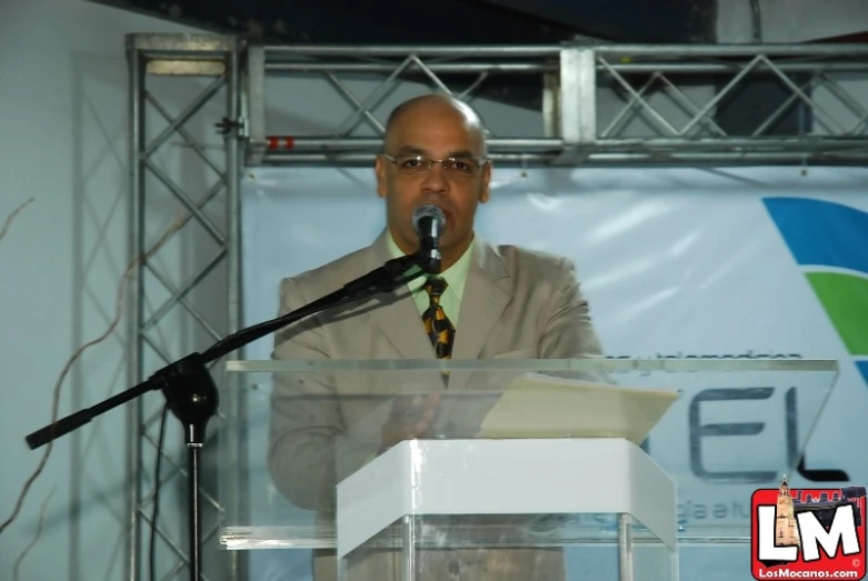 a man is speaking into a microphone and an object