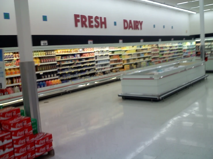 a grocery store aisle filled with empty shelves