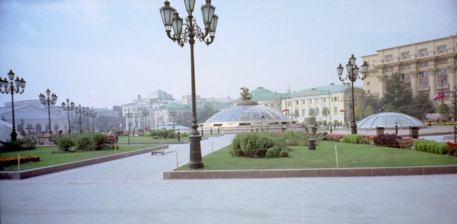 a city park with a large lawn and some very nice buildings