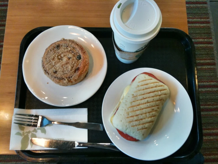 a breakfast plate is sitting on top of a black tray