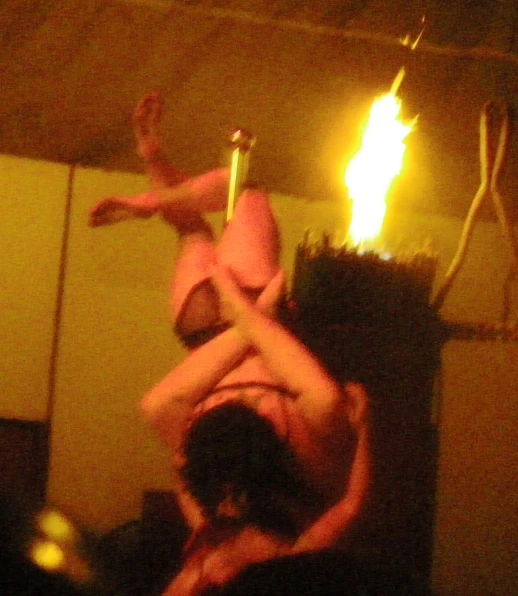 a woman upside down on top of another woman in a pink 