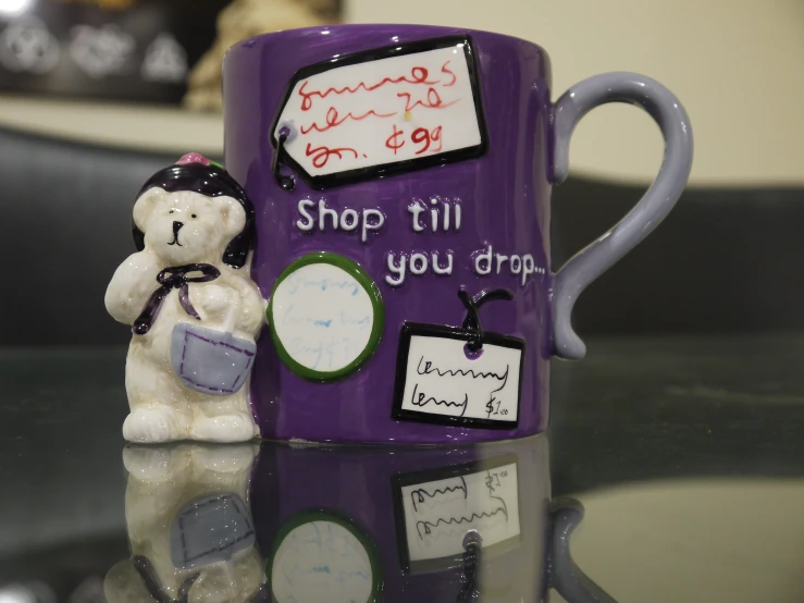 the mug has writing on it, and a bear