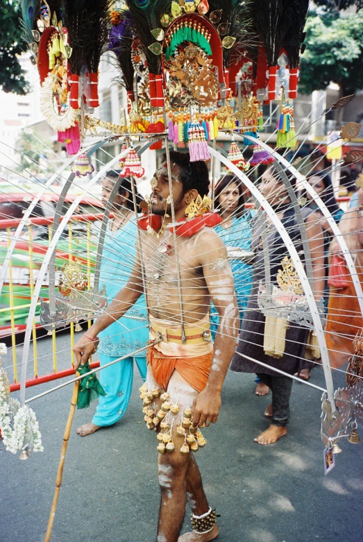 a man with an elaborate costume and stick in his hand