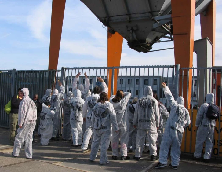 some people dressed in white on a bridge