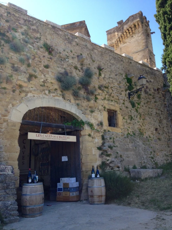 a stone building is built over by a wall