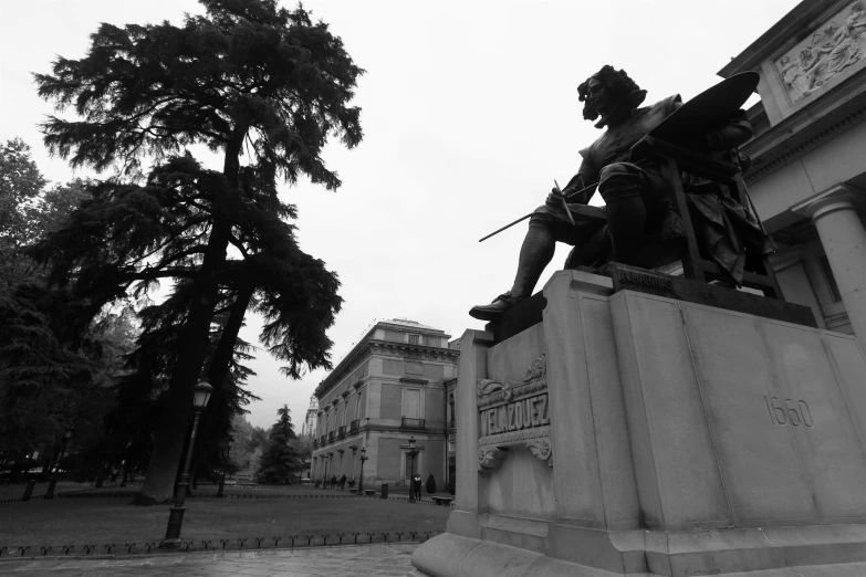 a statue of a man sitting on a bench