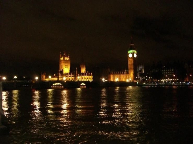 a city is lit up at night on the water