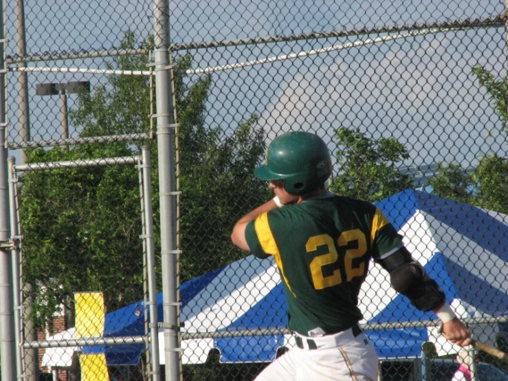 a baseball player in the middle of batting practice