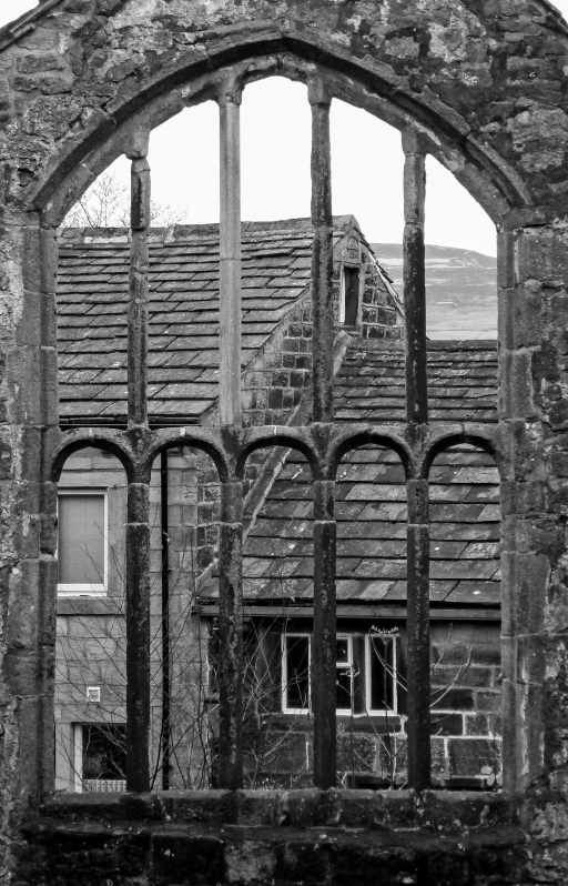 an old window with bars on one side and the back door open