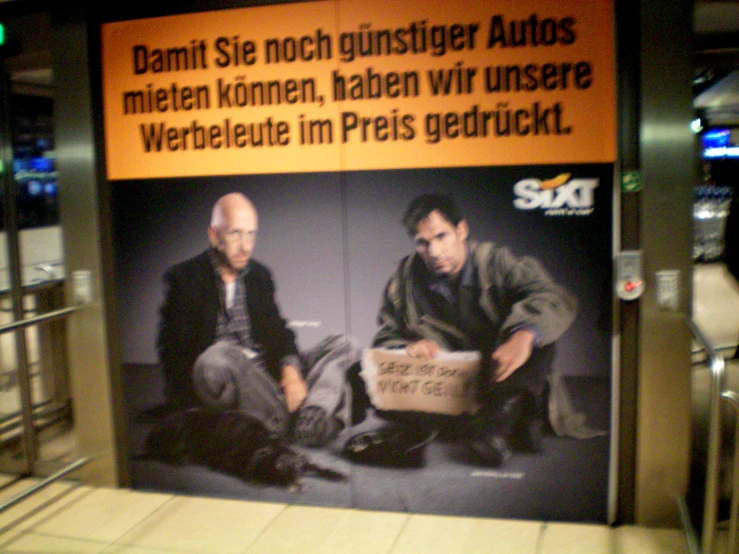 a poster of two men sitting next to each other