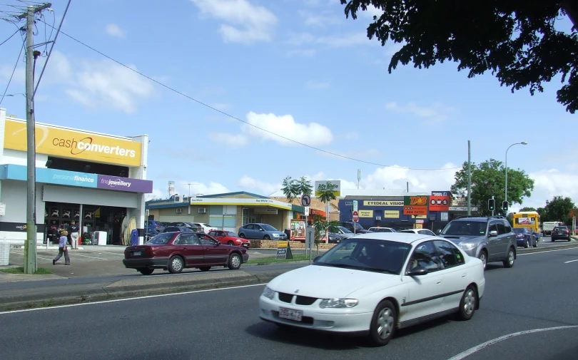 a bunch of cars drive down a street