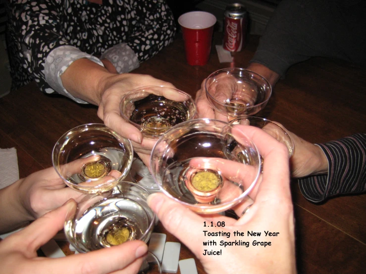 people holding glasses with wine next to each other