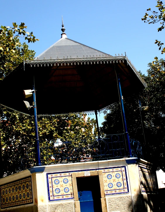 a small building with a tiled balcony and balcony