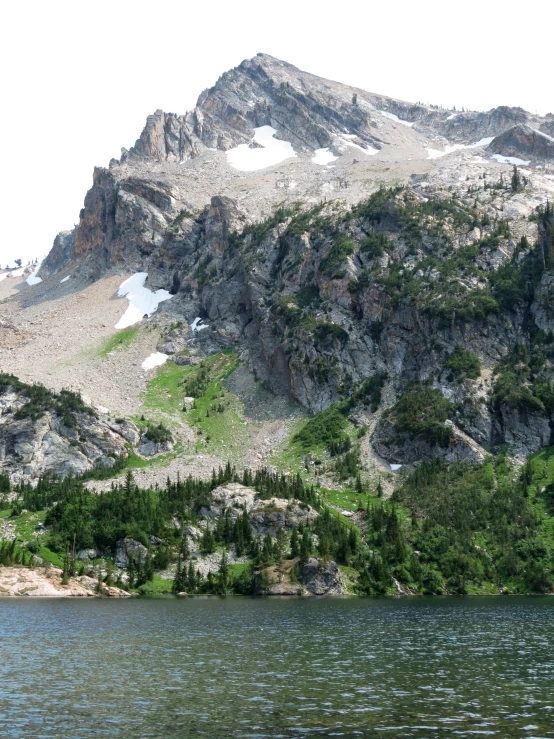 a mountain range is in the background as it reflects off the water