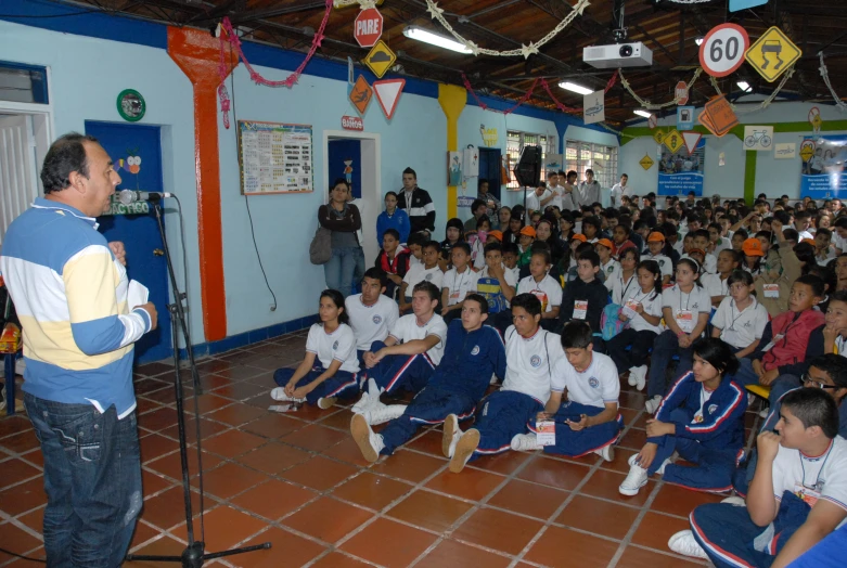 a boy teaching a class in a classroom