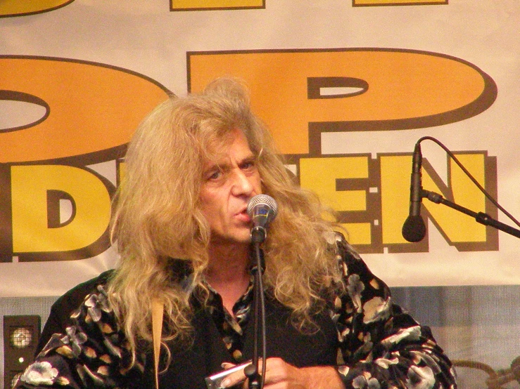 a man with a microphone speaking into a mic