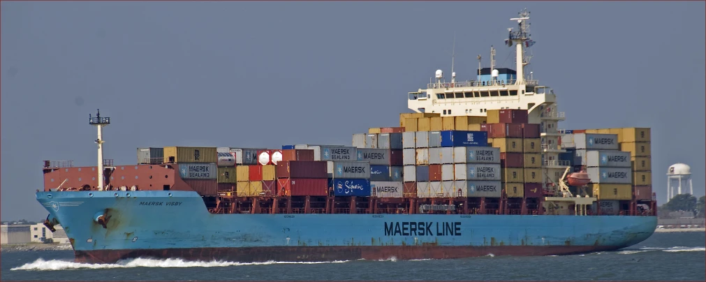 a large boat with multiple stacked containers on it