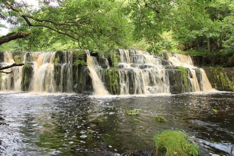 this is a very large waterfall in the woods