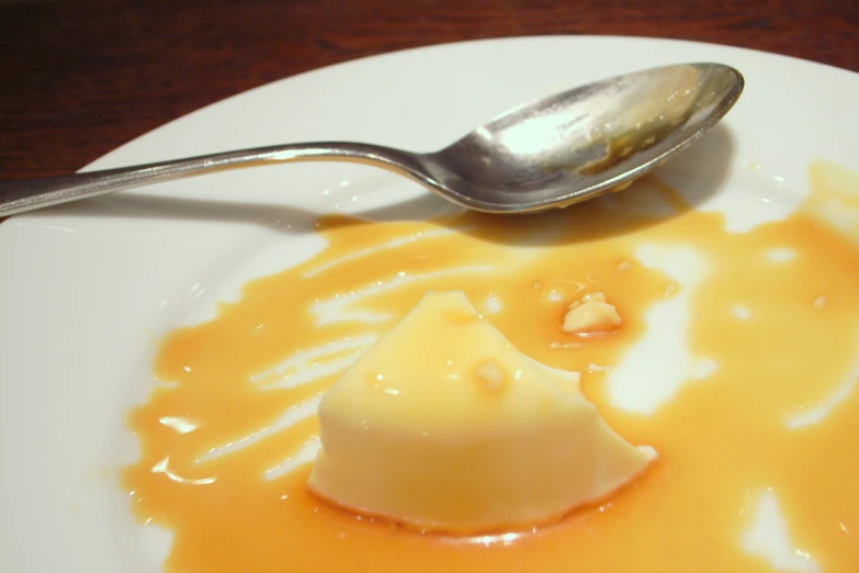 a spoon in a dessert is sitting on the plate