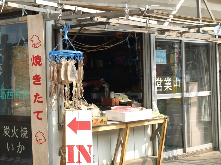 various items for sale sit on a stand outside a shop