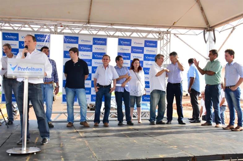 a group of people standing together by a stage