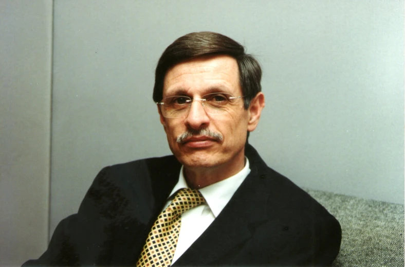 an image of a man wearing glasses and a suit