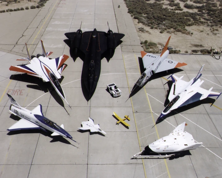 a bunch of fighter jets that are sitting on the ground