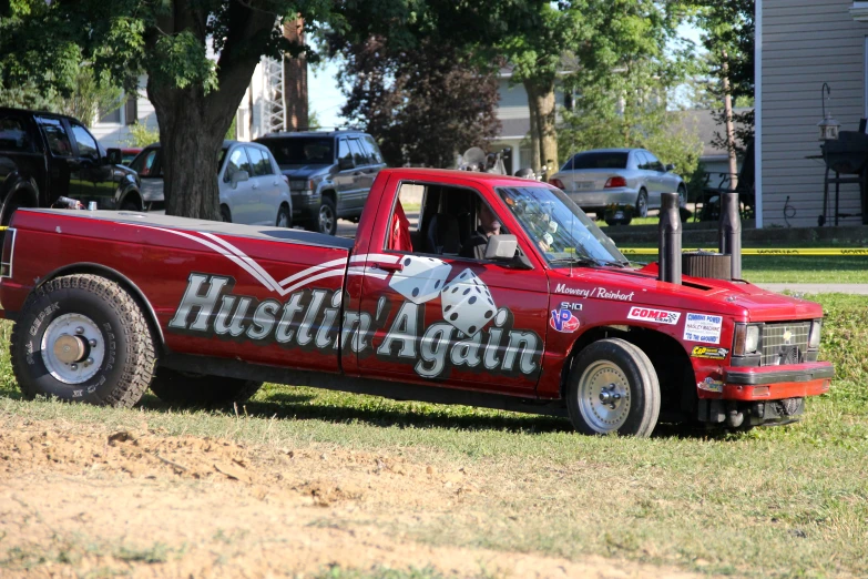 a red truck parked on the side of a road