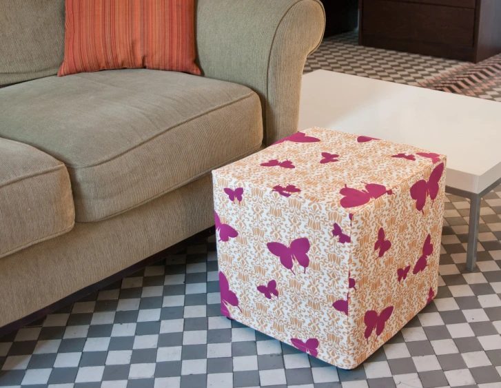 a brightly colored stool with pillows on top