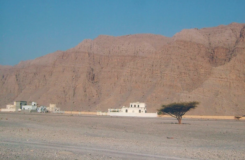 some mountains and a house in the desert