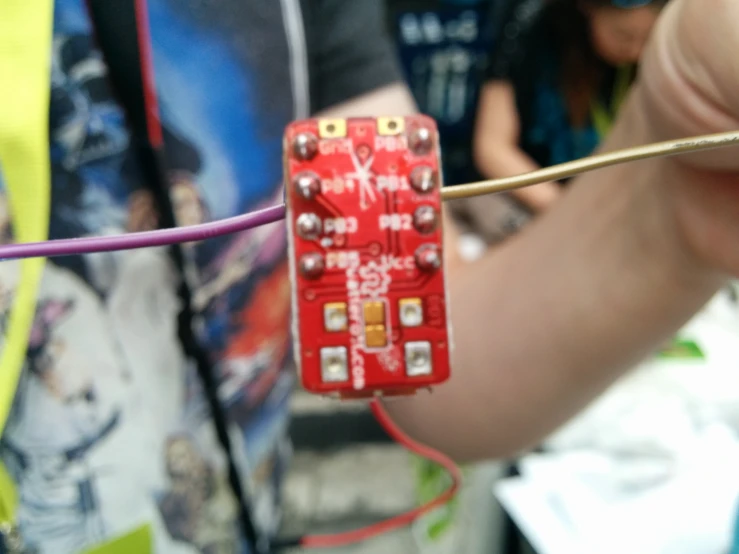 a tiny circuit board is being used to hold on to wires