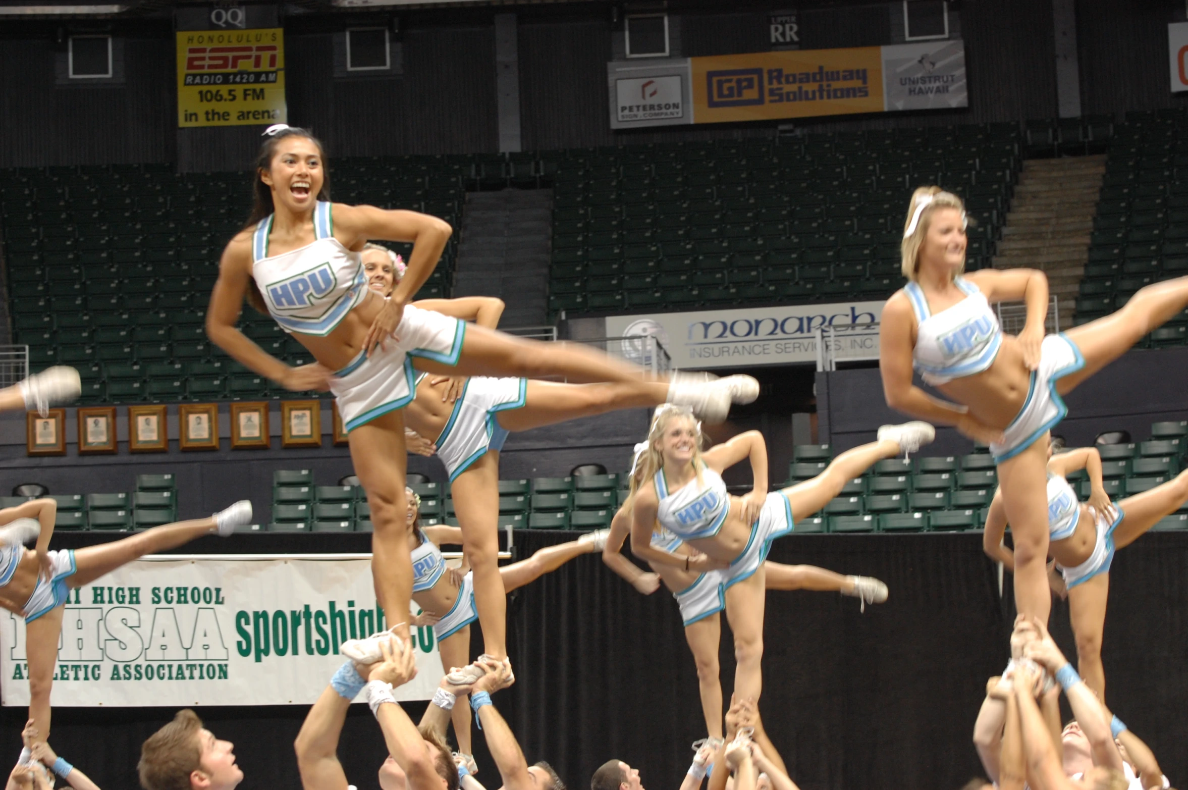 a cheerleader doing stunts with the crowd