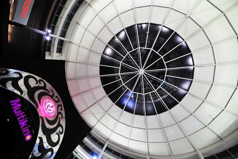 a circular ceiling in an airport terminal with lights