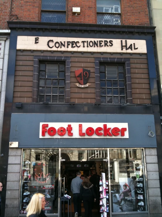 people are standing outside a pet locker in a street