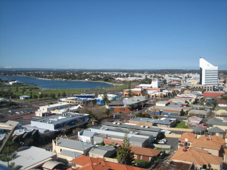 an aerial view of buildings with a lake in the background