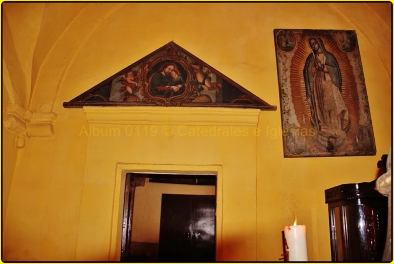 a yellow and white room has an old style painting hanging above the door