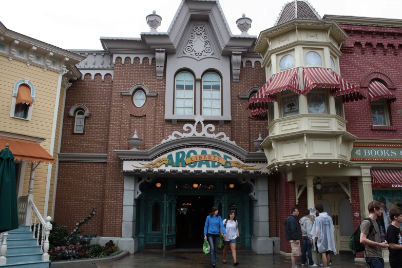 a group of people walking in front of an entrance