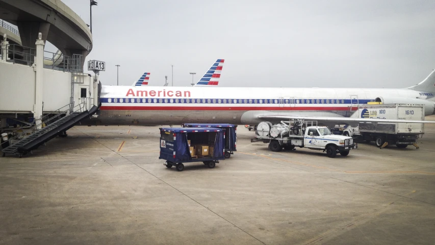 an airplane and a truck in the terminal at an airport