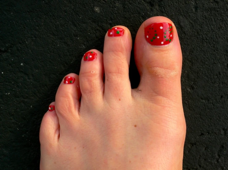a person with red nails and a polka dot pattern