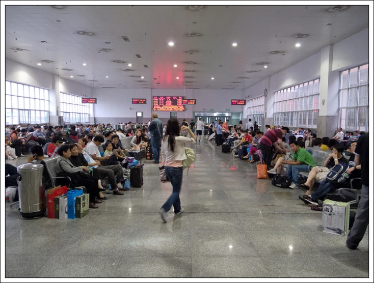 several people in an airport waiting for their luggage