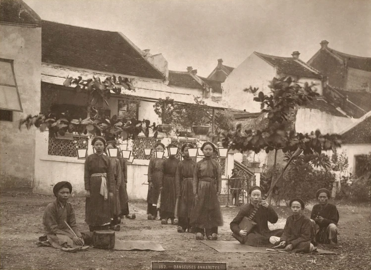 an old pograph shows a group of women wearing long dresses